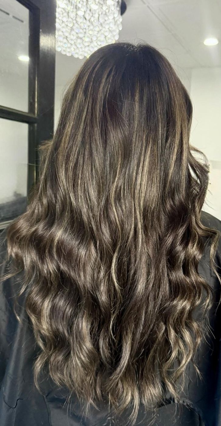 Long, full hand-tied extensions with soft highlights